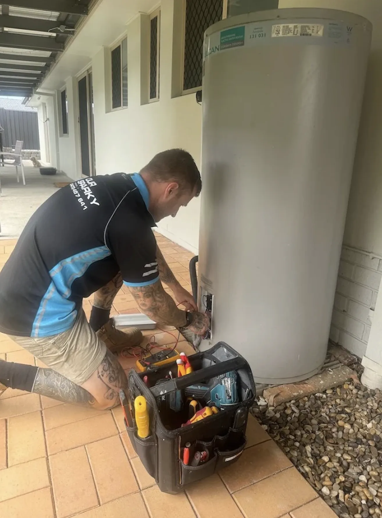 Our Sparky electrician repairing an electric hot water system in Hervey Bay